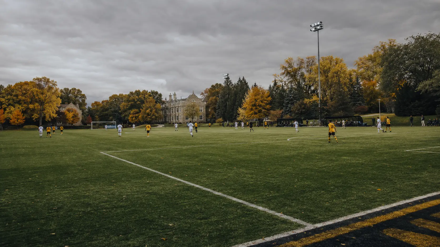 Outdoor college soccer match on an Ontario pitch in autumn